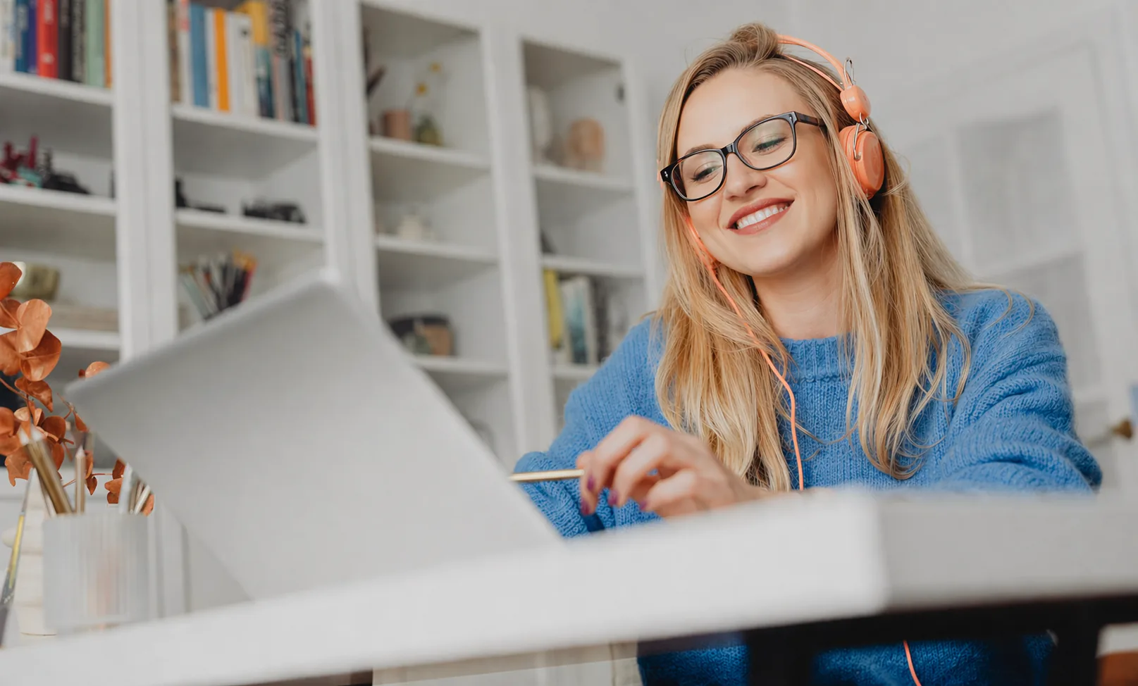 Woman studying at her laptop and smiling confidently