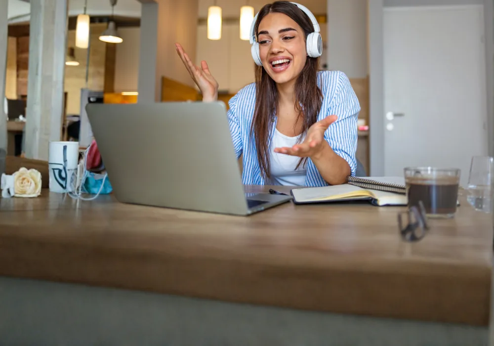 Woman studying at her laptop and smiling confidently